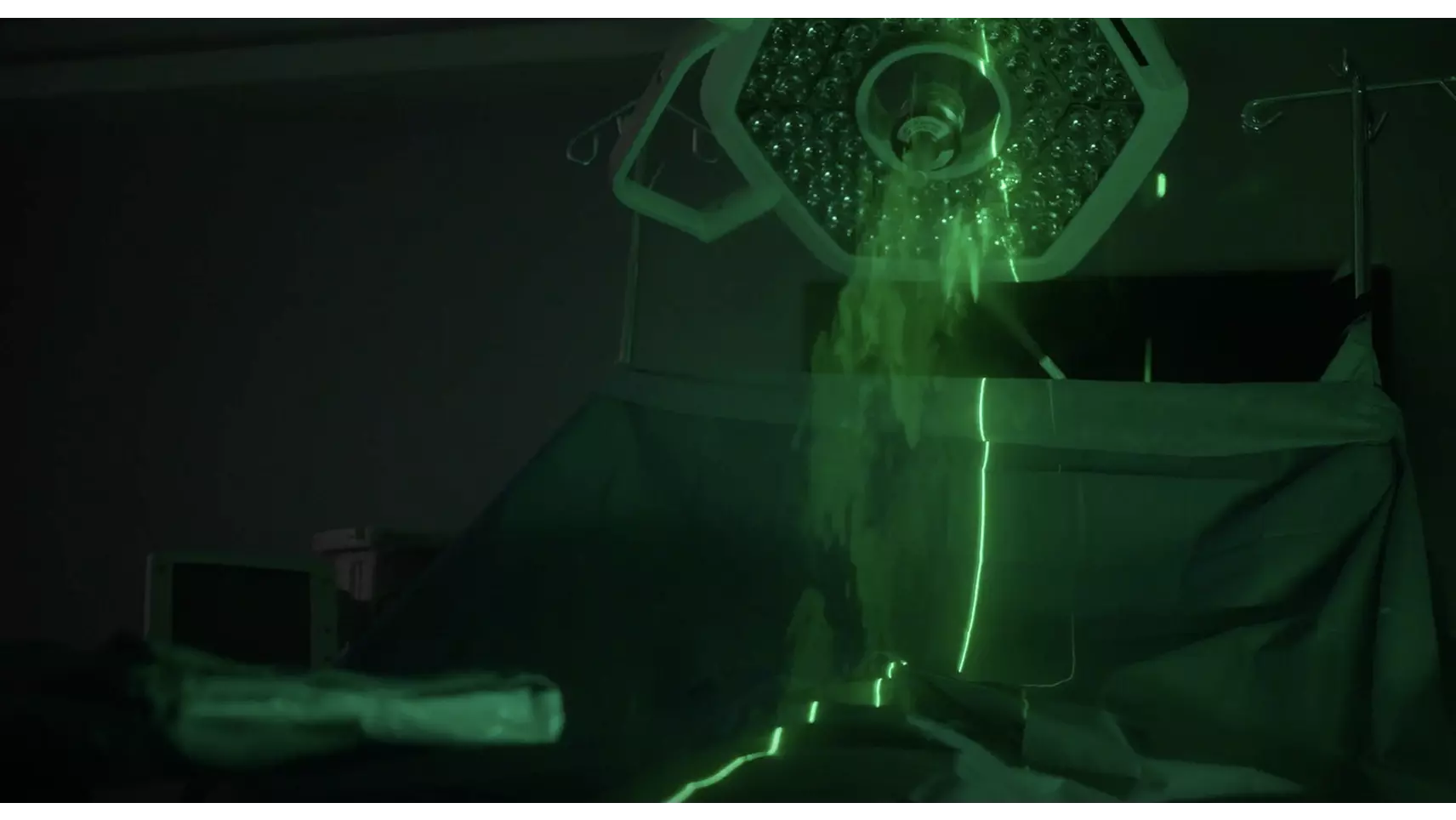 A laser is used to illuminate airflow in an operating room, showing how a surgical light is blocking ventilation